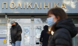 People in protective masks near the clinic
