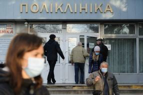 People in protective masks near the clinic