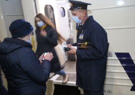 The conductor checks the documents of the passenger