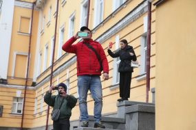 People take photos on the mobile phones of the protesters