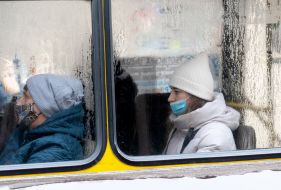 Passengers in respiratory masks in a minibus