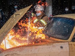 Practicing fire extinguishing techniques in a car