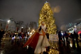 Animator in a costume of St. Nicholas near the main Christmas tree in Lviv