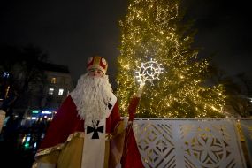 Animator in a costume of St. Nicholas near the main Christmas tree in Lviv