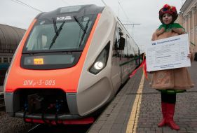 A girl in a national costume holds a symbolic ticket for the Slobozhansky Express train on the platform of Kharkiv-Pasazhyrskyi station