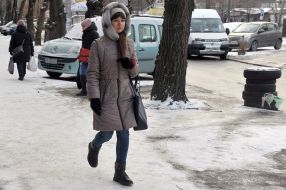The girl walks on the sidewalk