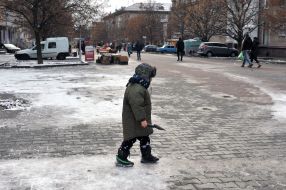 The boy crosses the road