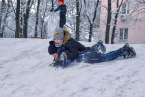 Children play on a snow slide