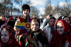 A group of carolers with a Christmas star