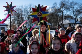 A group of carolers with a Christmas star