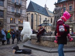 Street musician and animator in a bear costume