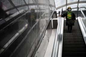Woman going down the escalator