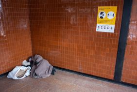A homeless woman sleeps on the floor  in Kiev