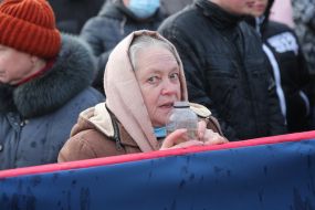 Woman holding a jar of consecrated water