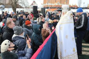 The priest sprinkles the faithful with holy water