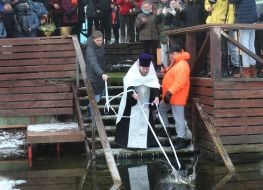 The priest consecrates the water