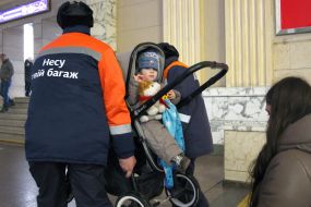 Porters near a man in a wheelchair at the Central Railway Station