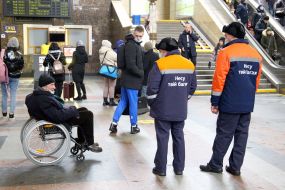 Porters near a man in a wheelchair at the Central Railway Station