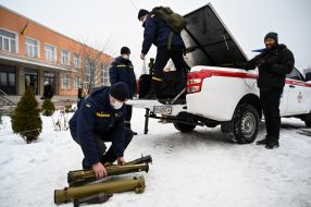 Rescuers from the State Emergency Service unload hand-held anti-tank grenade launchers from the car