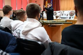 The rescuer of the SES demonstrates students samples of explosives and ammunition