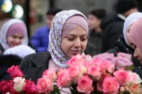 The participant of the action presents flowers