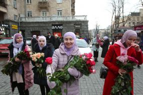 Participants of the action with bouquets of roses