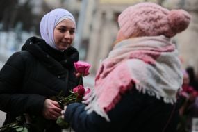 The participant of the action presents flowers
