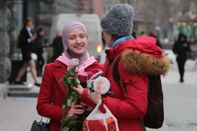 The participant of the action presents flowers