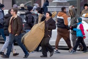 A man carries a music instrument