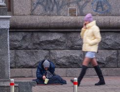 Elderly woman asking for alms
