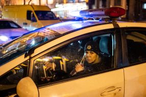 A police officer in a car during a march of remembrance