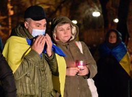 People with flags of Ukraine near the memorial on the Alley of the Heavenly Hundred