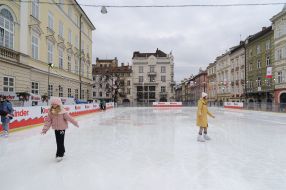 People skate on ice at Rynok square in Lviv
