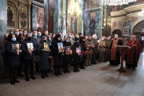 Parents hold portraits of children who died in the anti-terrorist operation, government officials and members of the ATO-OOS