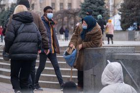 Пожилая женщина просит милостыню