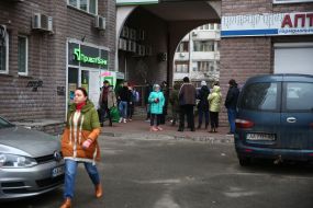 People stand in line at the ATM