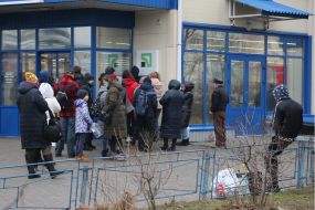 People stand in line at the ATM