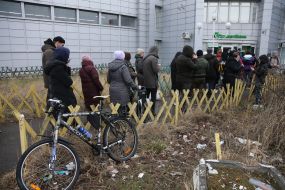 People stand in line at the ATM