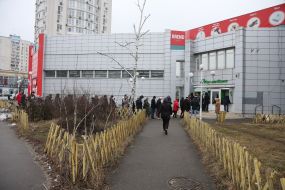 People stand in line at the ATM