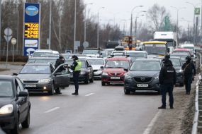 Law enforcement officers check the documents of drivers