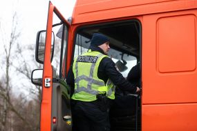 Law enforcement officers check the documents of drivers