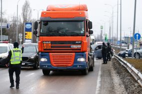Law enforcement officers check the documents of drivers