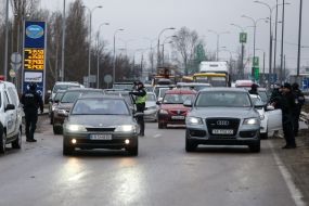 Law enforcement officers check the documents of drivers