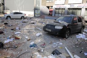 Destruction near a residential building damaged by shelling