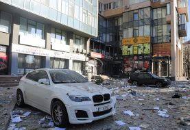 Destruction near a residential building damaged by shelling