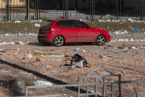 Destruction near a residential building damaged by shelling