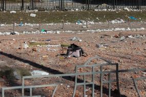 Destruction near a residential building damaged by shelling