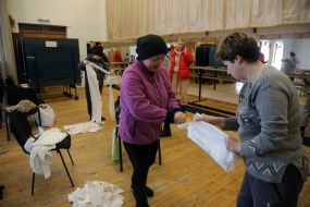 Volunteers weave camouflage nets