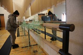 Volunteers weave camouflage nets