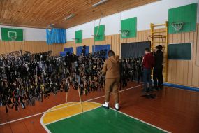 Volunteers weave camouflage nets